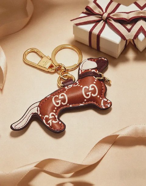 Counterfeit Gucci GG Emblem Dog Charm detail view visual reference