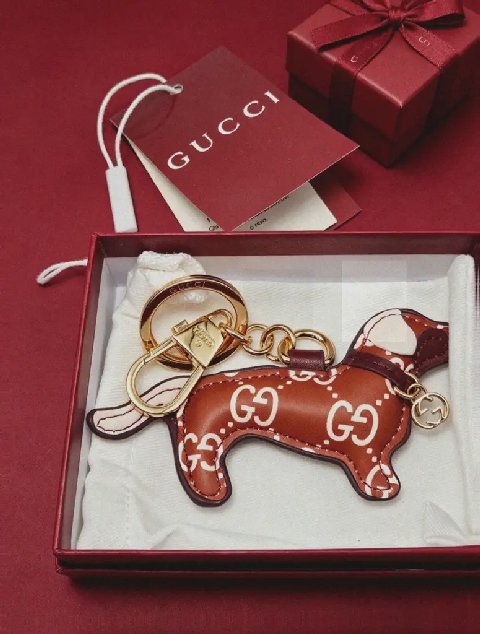 Counterfeit Gucci GG Emblem Dog Charm detail view visual reference